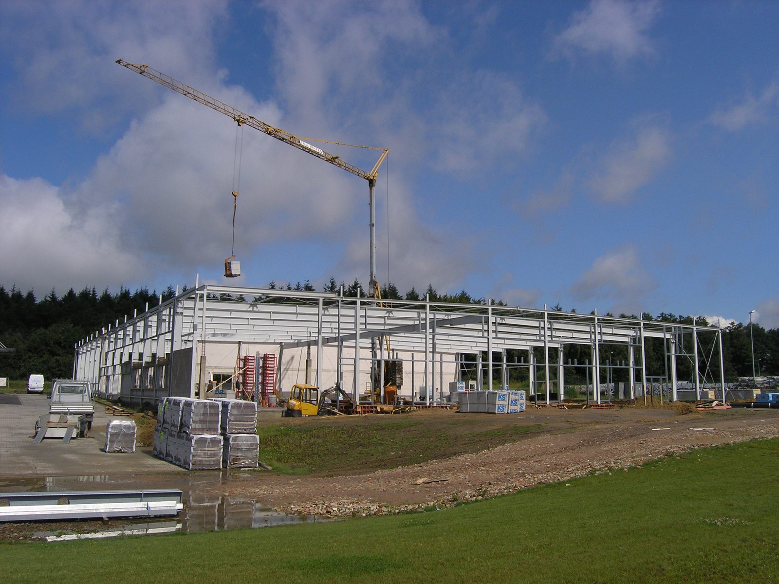 Der Kran über dem wachsenden Hallenrohbau